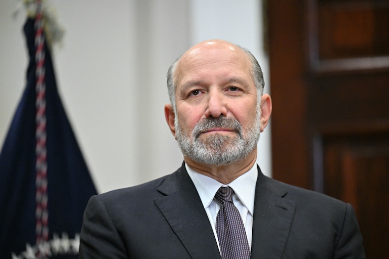 Commerce Secretary Howard Lutnick stands in the White House