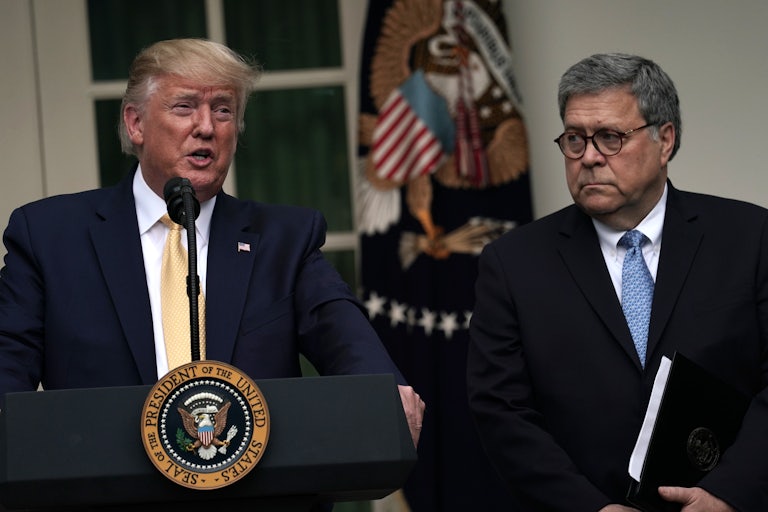 Donald Trump speaks at the presidential podium while Bill Barr looks on