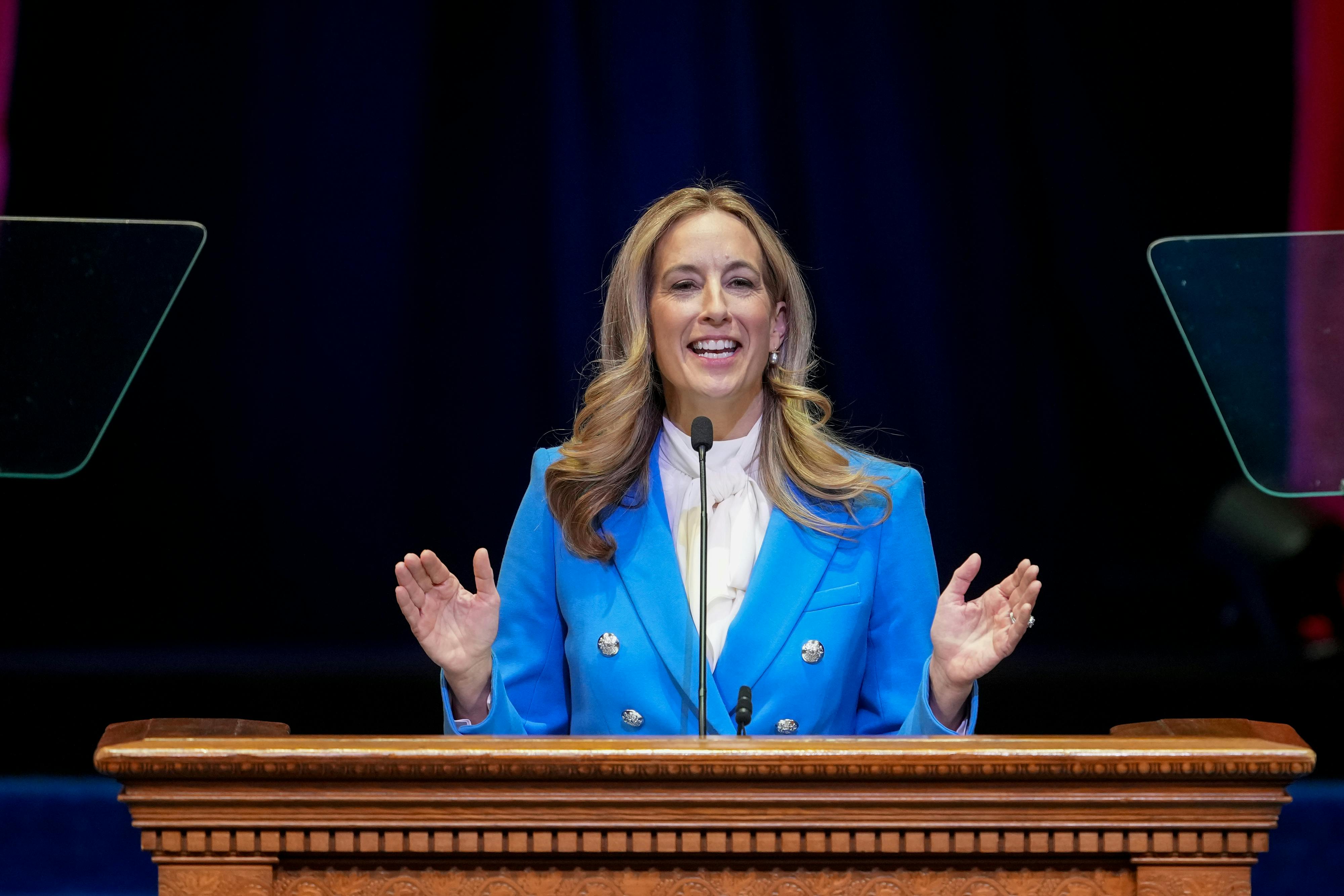New Jersey Governor Mikie Sherill gestures with both hands while speaking at a podium