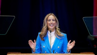 New Jersey Governor Mikie Sherill gestures with both hands while speaking at a podium