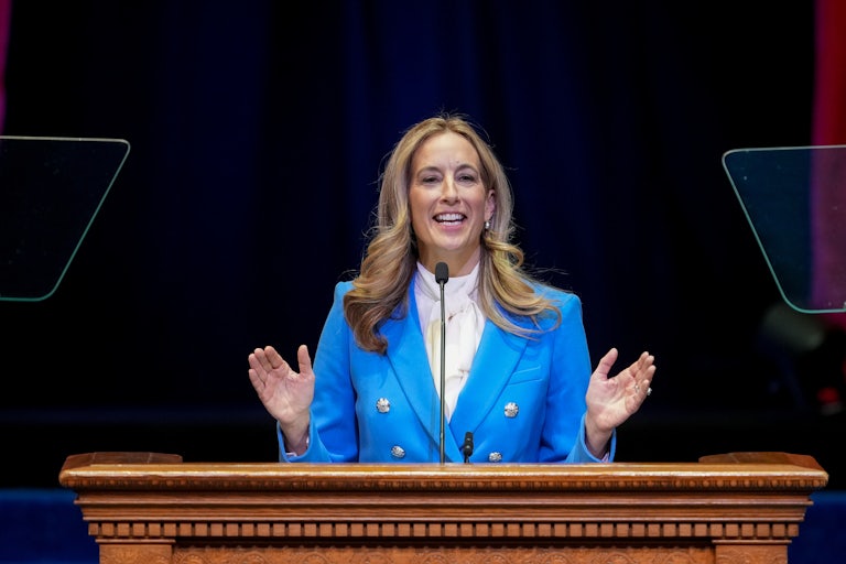 New Jersey Governor Mikie Sherill gestures with both hands while speaking at a podium