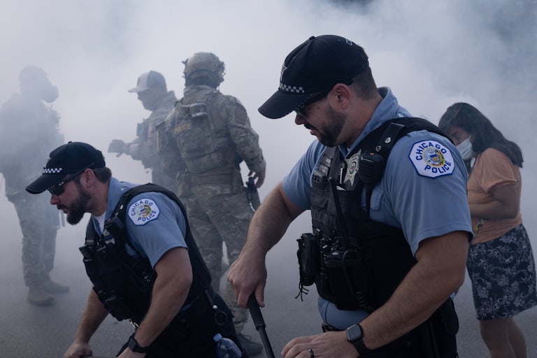 Chicago police officers surrounded by tear gas