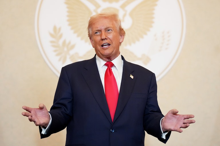 Donald Trump holds his hands out to the side while speaking