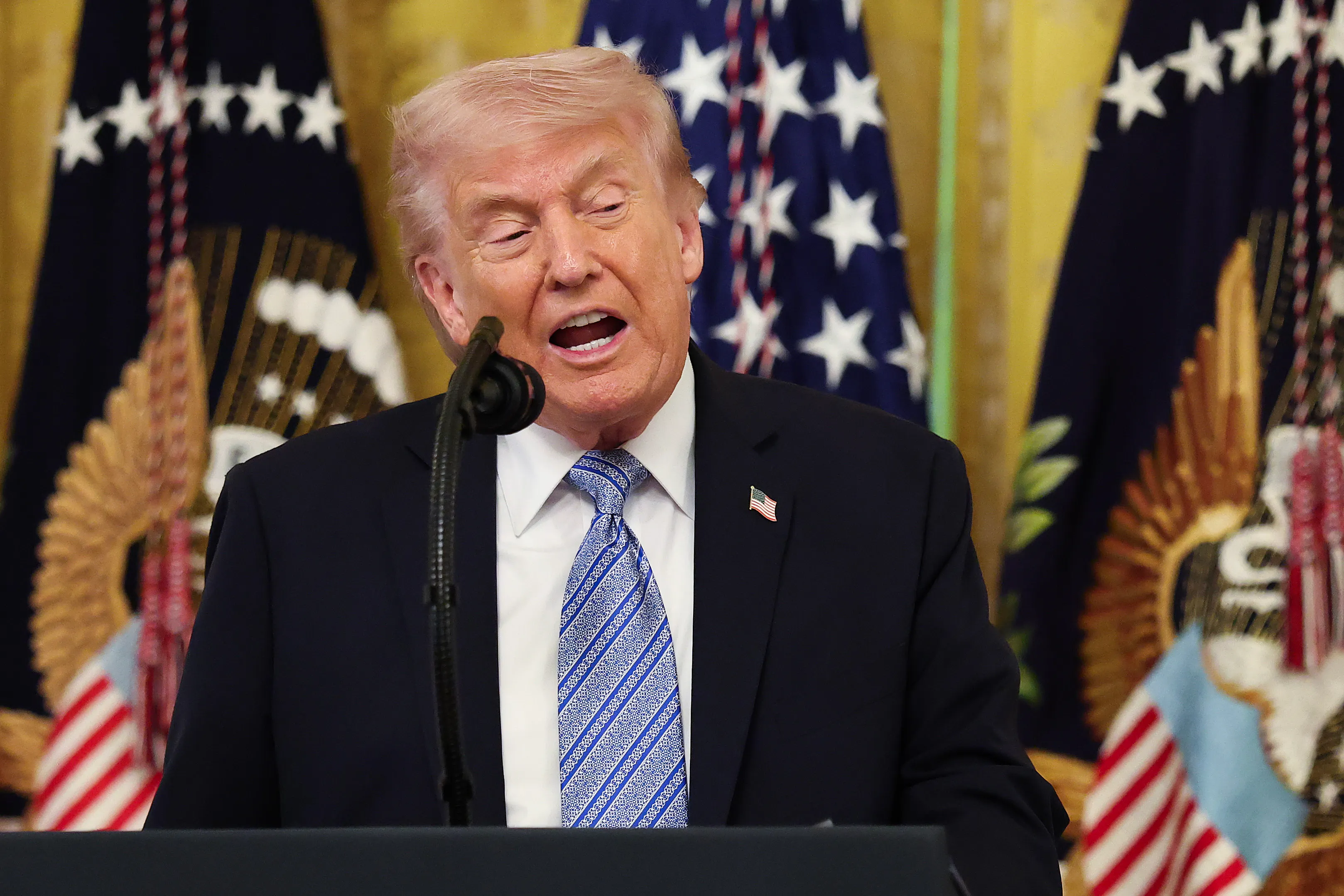 Donald Trump speaks at a podium during a White House event