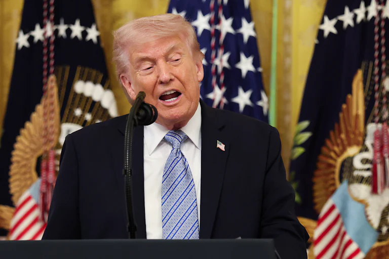 Donald Trump speaks at a podium during a White House event