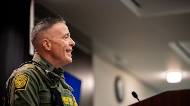 Customs and Border Protection commander Gregory Bovino smiles while speaking during a press conference