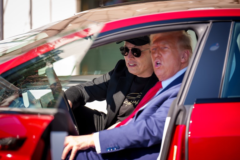 Donald Trump speaks while sitting in a Tesla Model 3 with Elon Musk