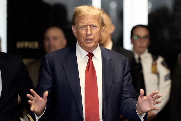 Donald Trump talks while gesturing with both hands