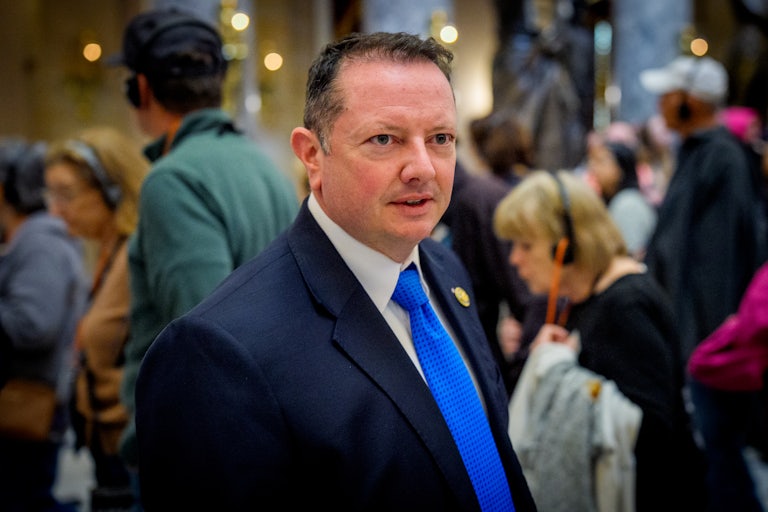 Representative Burlison walks out of a press conference.