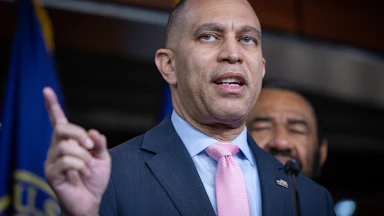 House Minority Leader Hakeem Jeffries raises a finger while speaking
