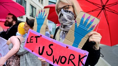 Sex workers hold placards during a protest