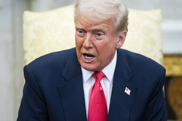 Donald Trump speaks while sitting in the Oval Office