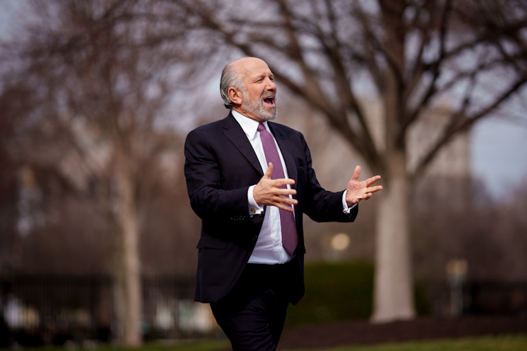 Commerce Secretary Howard Lutnick gestures and speaks to reporters outside the White House