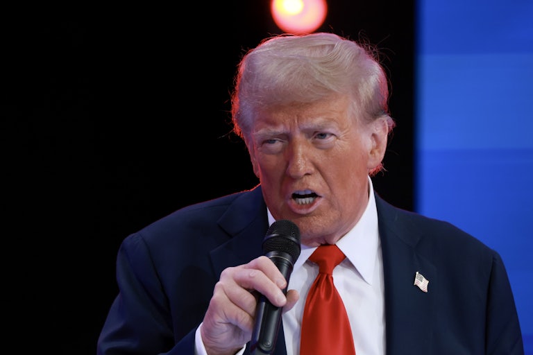 Donald Trump speaking on a mic