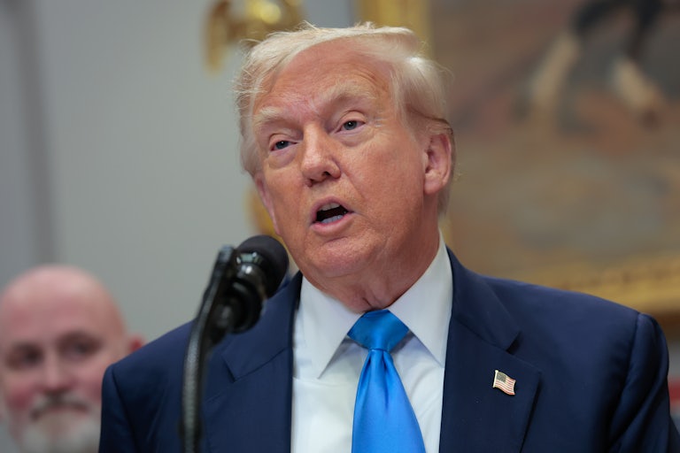 Donald Trump speaks into a microphone