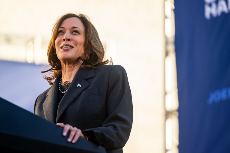 Kamala Harris smiles while at a lectern