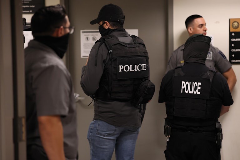 Masked federal agents wearing Police vests.