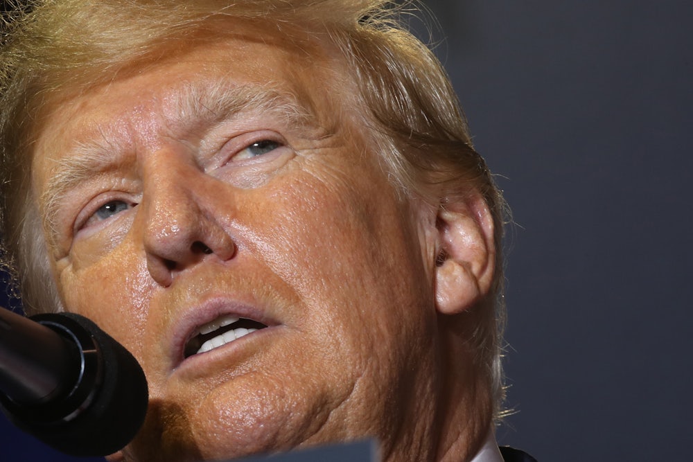 Donald Trump speaks into a microphone.