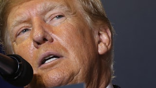 Donald Trump speaks into a microphone.