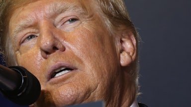 Donald Trump speaks into a microphone.