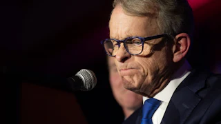 Ohio Governor Mike DeWine faces the prospect of having to sign SB1 into law, which critics say will touch off a statewide brain drain that could decimate the state's economy.
