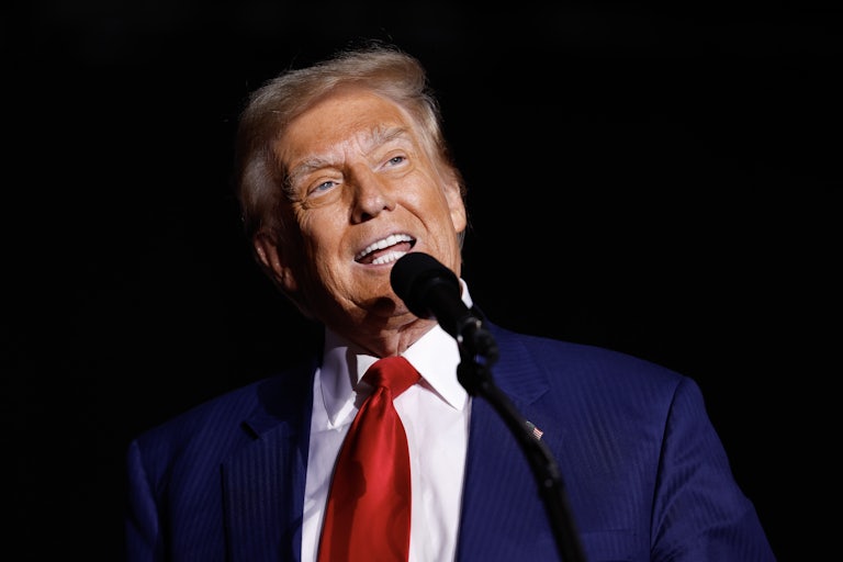 Donald Trump makes a weird face while speaking at a mic