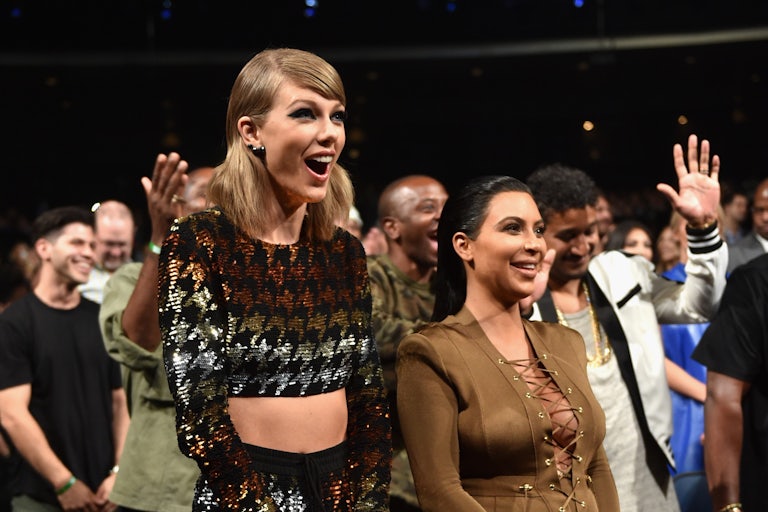 Taylor Swift and Kim Kardashian smile and stand next to each other