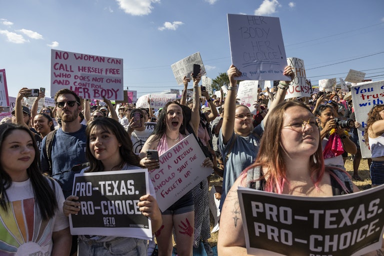 People hold up pro-abortion rights signs at a protest in Austin, Texas, in 2022