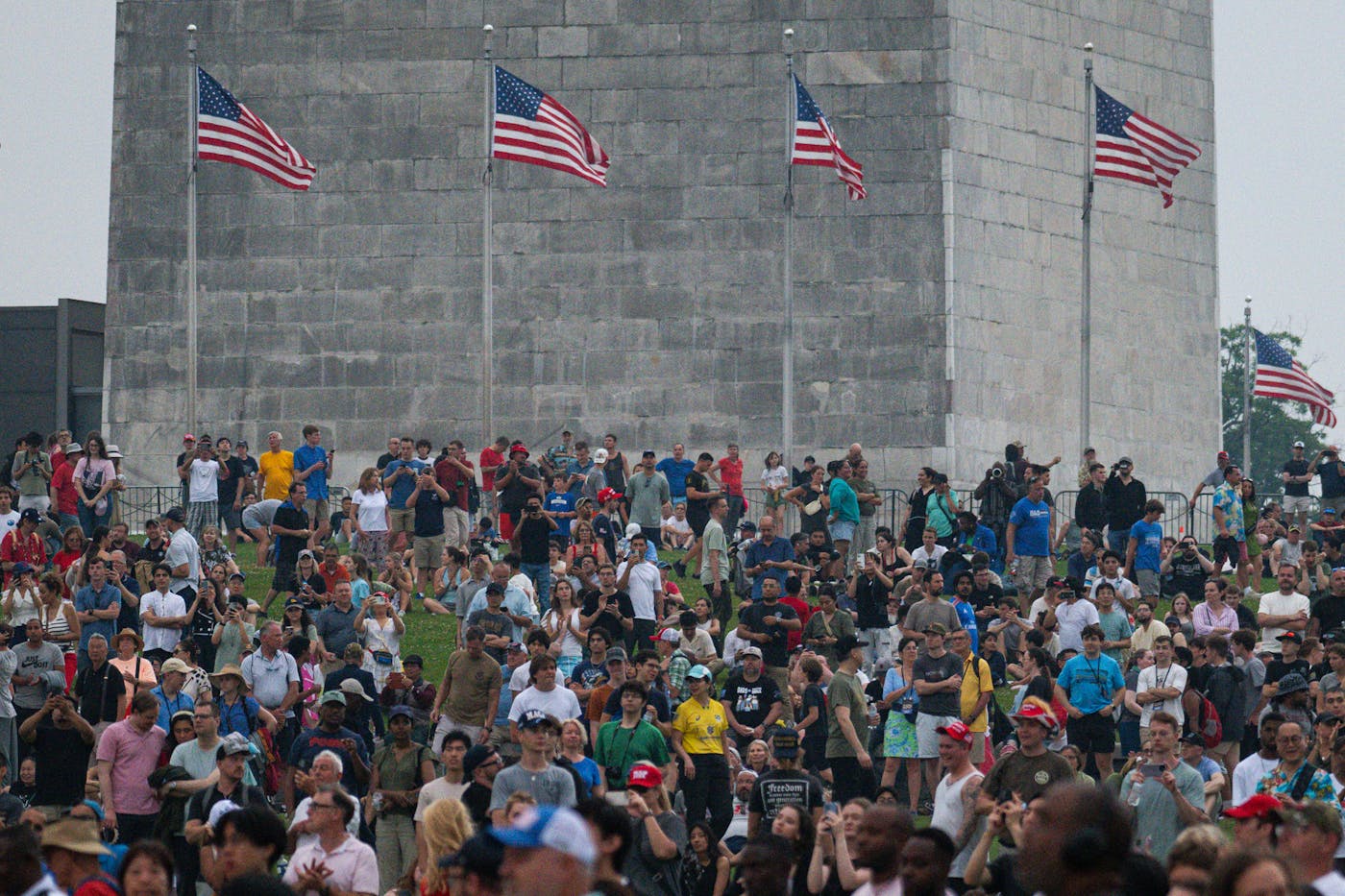 A crowd at the base the Washington Monument, a parade spectator area, could see screens televising the parade. 