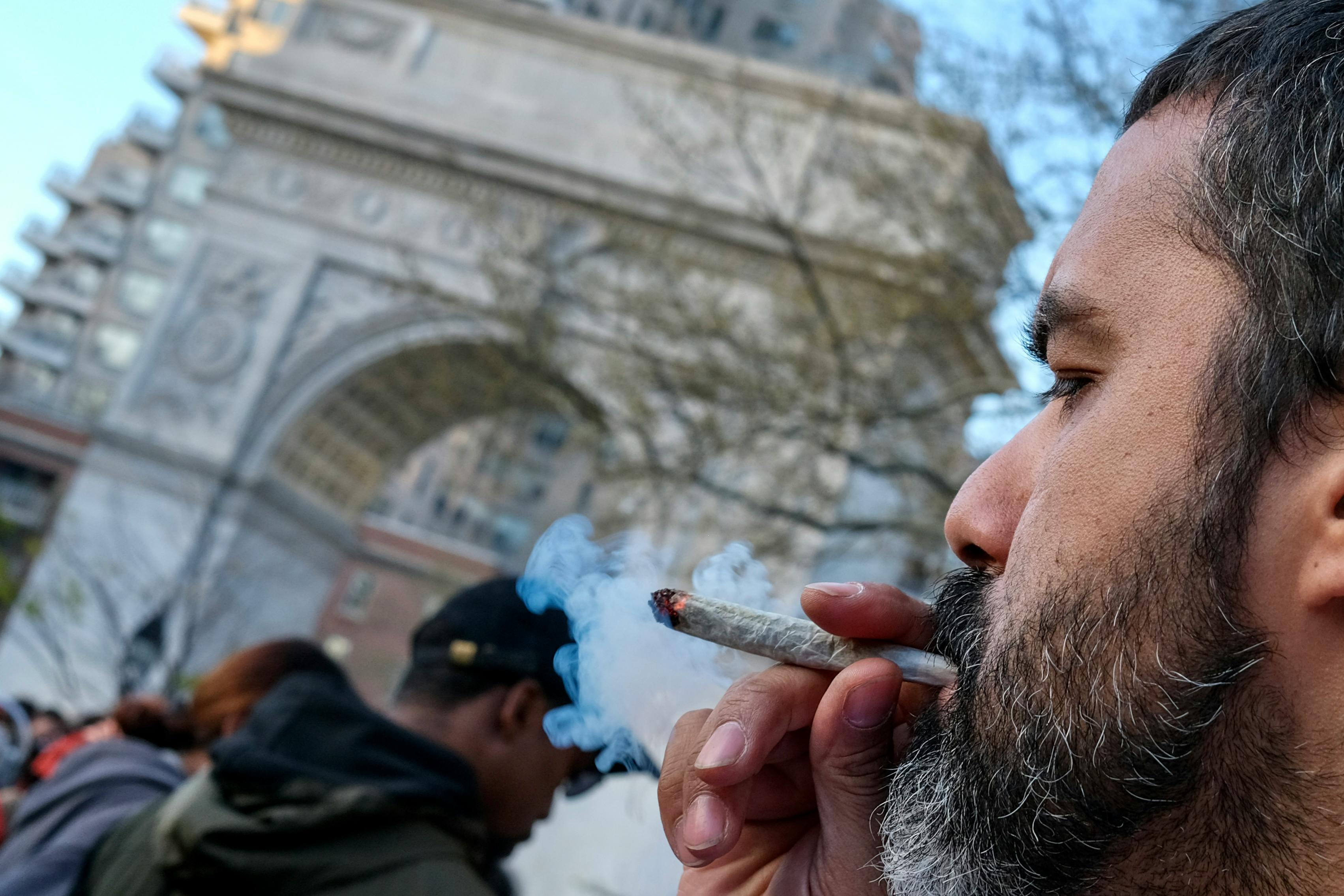 A marijuana enthusiast smokes a joint to celebrate 4/20 on World Weed Day in Washington Square Park.