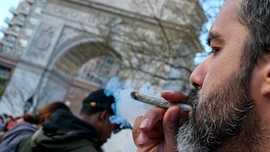 A marijuana enthusiast smokes a joint to celebrate 4/20 on World Weed Day in Washington Square Park.