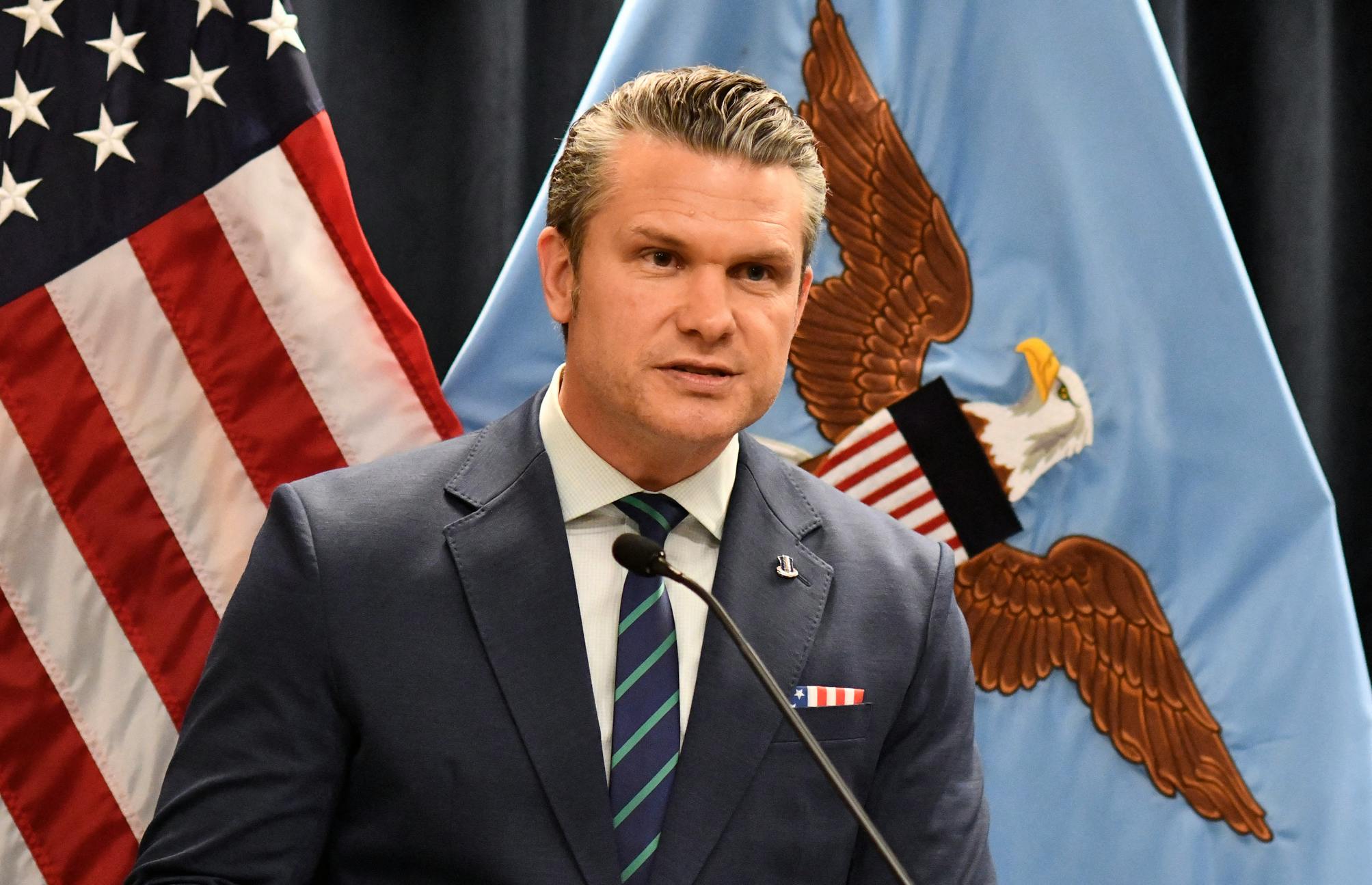 Defense Secretary Pete Hegseth speaks at a microphone during a press briefing