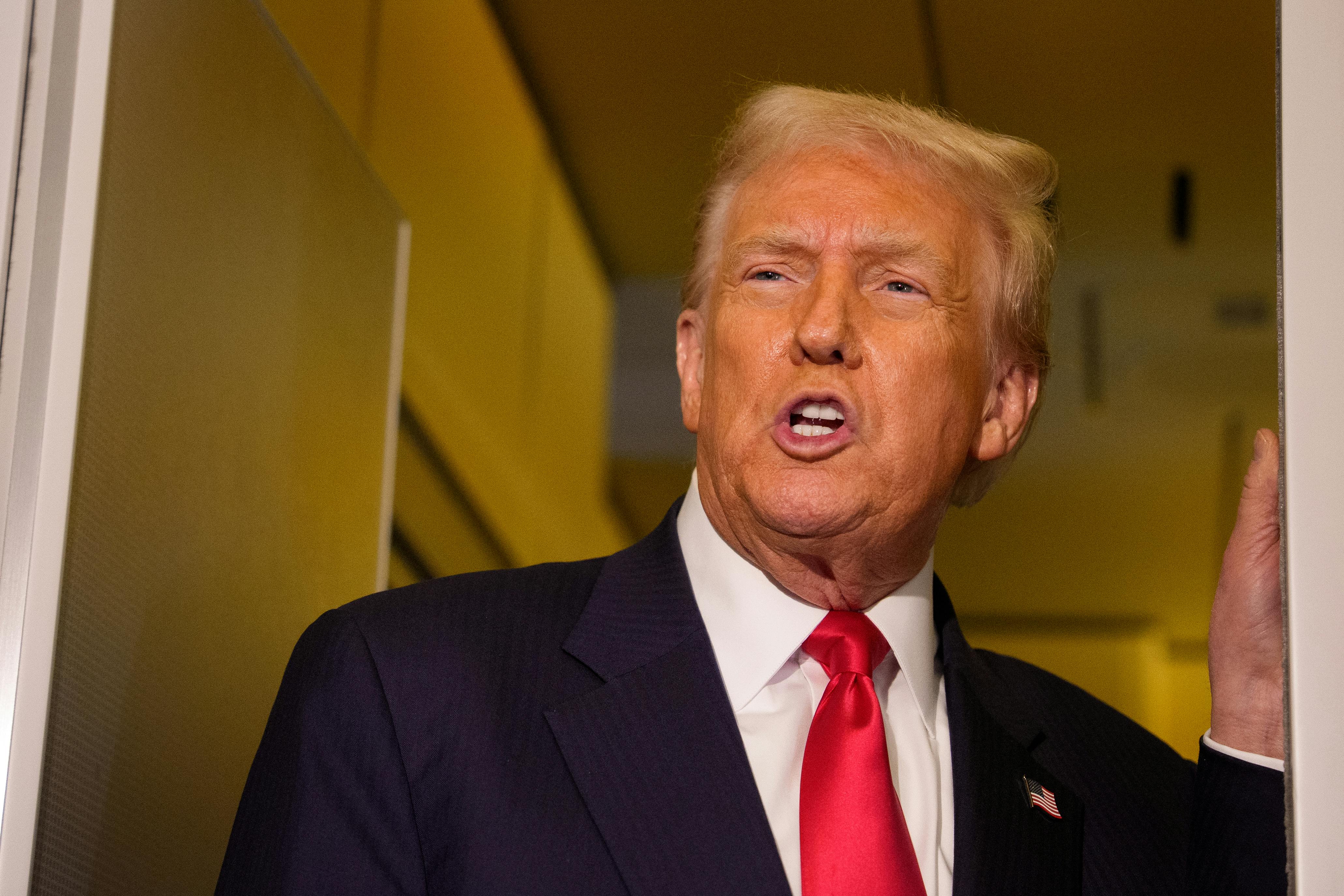 Donald Trump speaks to reporters on Air Force One