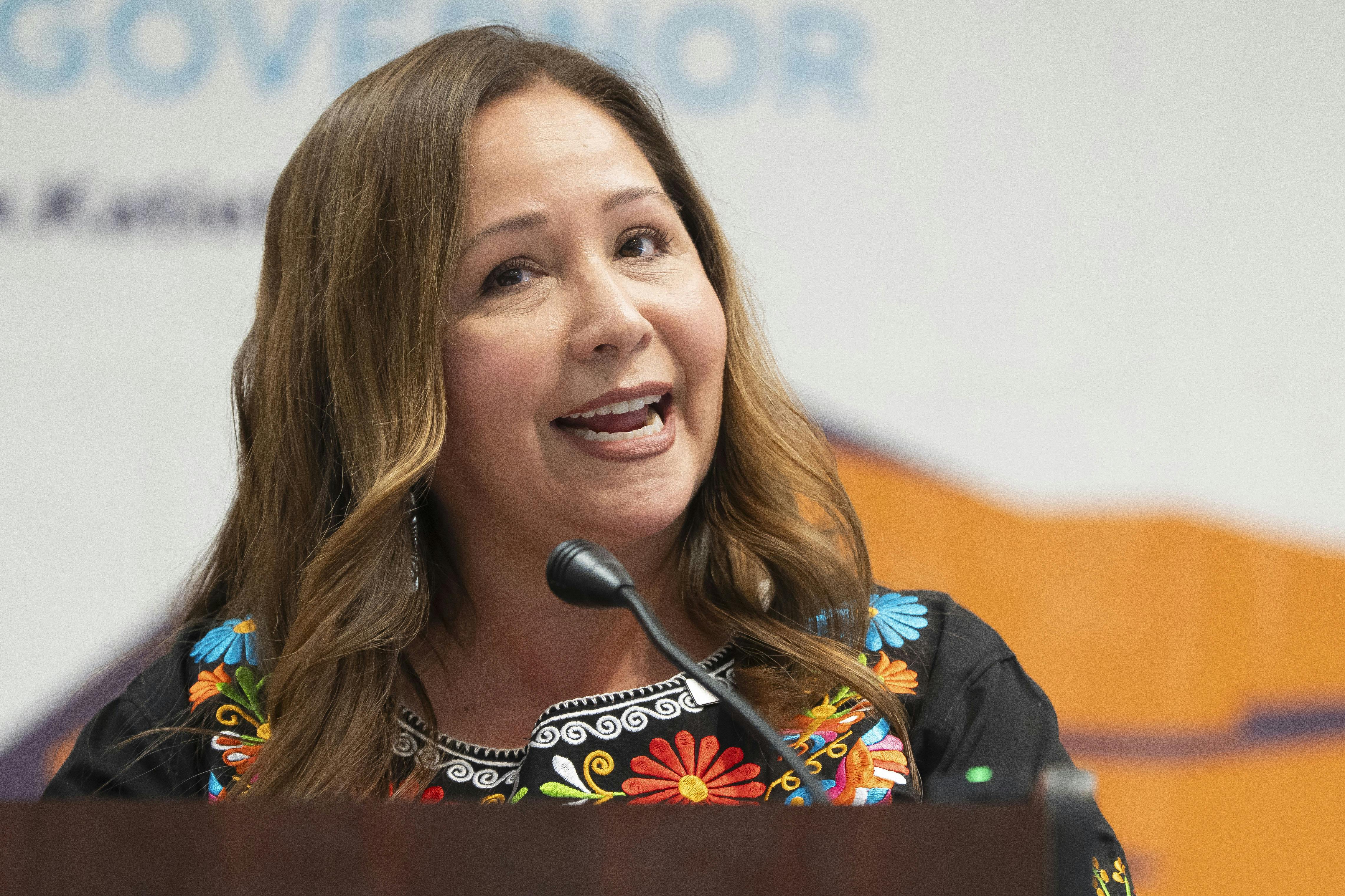 Representative Adelita Grijalva speaks at a podium.