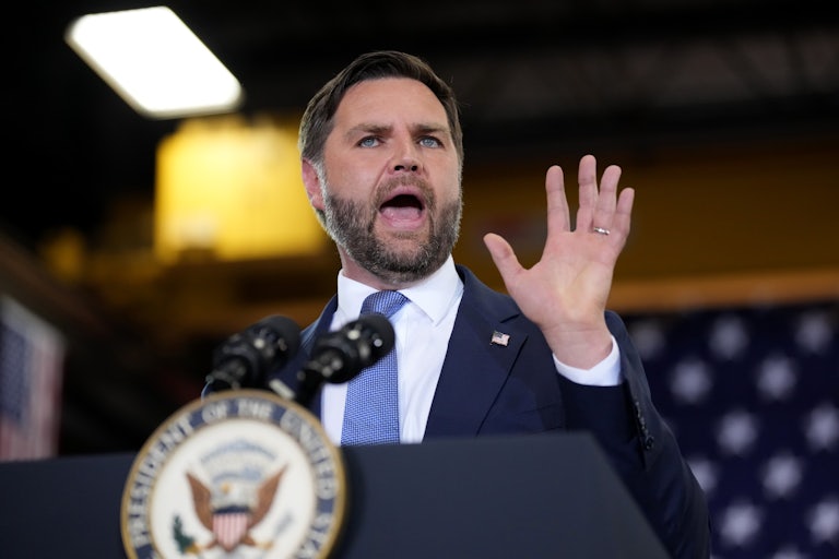 JD Vance speaks at the presidential podium with his mouth wide open