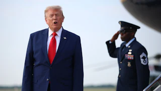 Donald Trump shouts at reporters after disembarking from Air Force One.