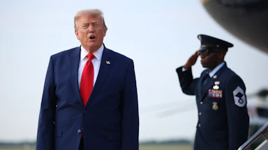 Donald Trump shouts at reporters after disembarking from Air Force One.