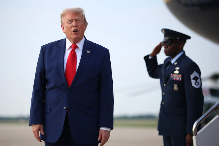 Donald Trump shouts at reporters after disembarking from Air Force One.