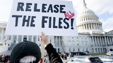 A person holds up a sign that says, “Release all the files!” outside the Capitol