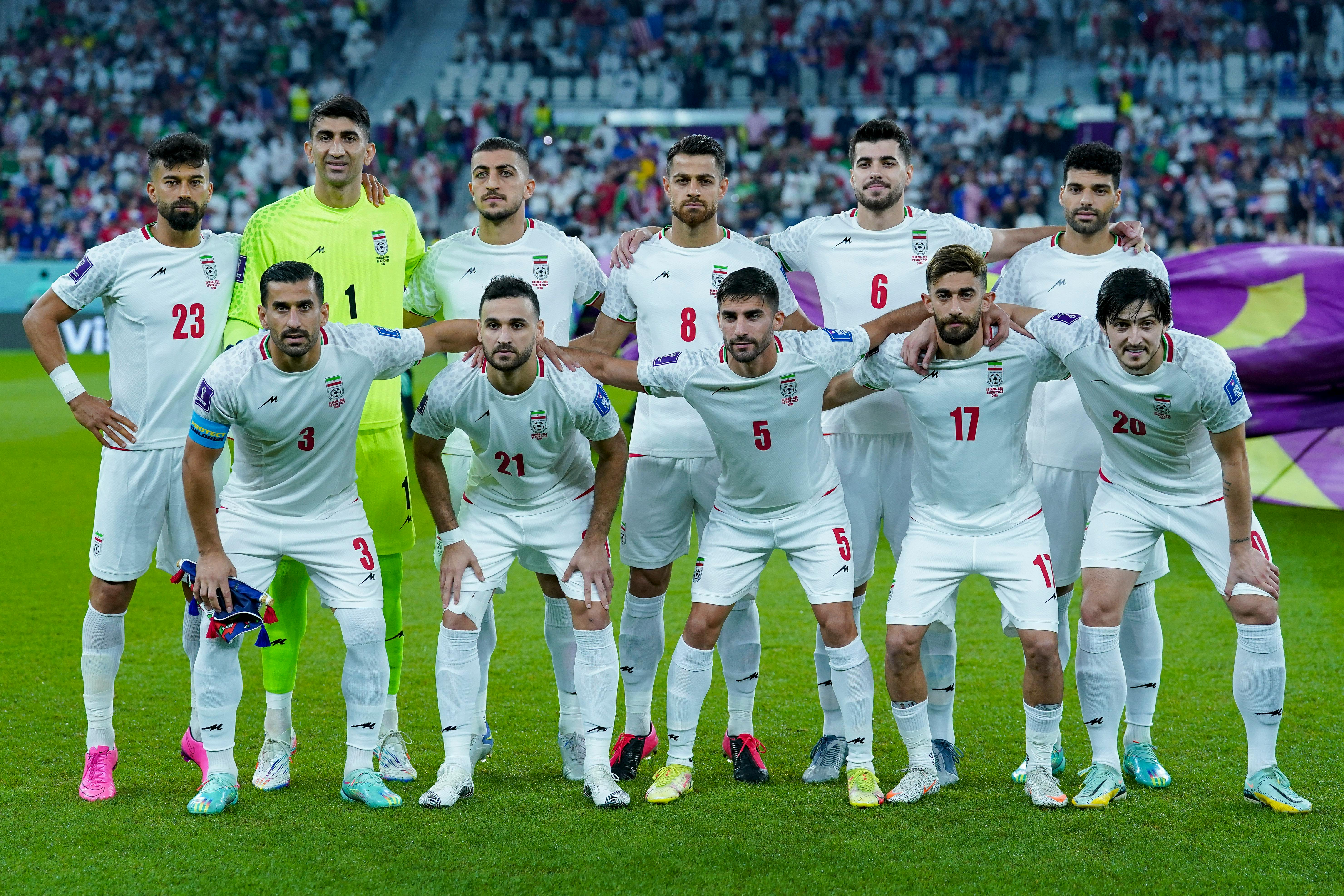 The Iranian men’s soccer team pose for a team photo on the field at the 2022 FIFA World Cup in Doha, Qatar.