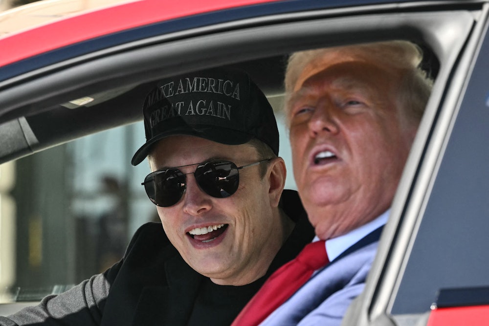 Musk and Trump smile while sitting in a Tesla.
