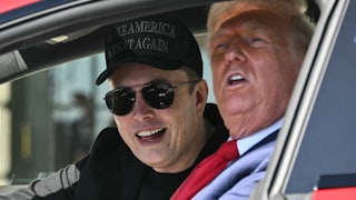 Musk and Trump smile while sitting in a Tesla.
