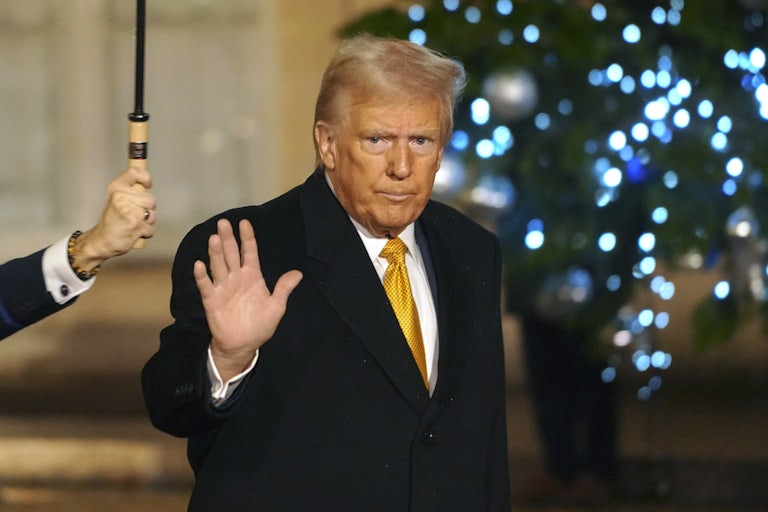 Donald Trump waves while walking