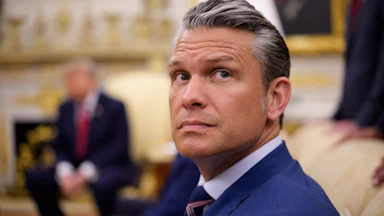 Defense Secretary Pete Hegseth looks up while seated in the Oval Office of the White House