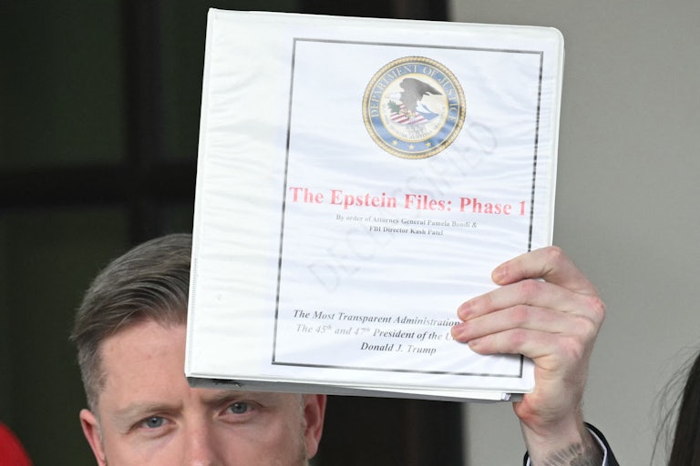 Far-right influencer Rogan O'Handley, also known as "DC Draino," stands outside the White House and holds up a binder labeled "The Epstein Files: Phase 1"