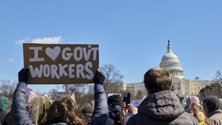 People participate in a protest against the Trump administration’s mass firing of government workers and civil servants in front of the Capitol building in Washington D.C. on Presidents’ Day, Feb. 17, 2025.