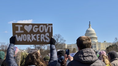 People participate in a protest against the Trump administration’s mass firing of government workers and civil servants in front of the Capitol building in Washington D.C. on Presidents’ Day, Feb. 17, 2025.