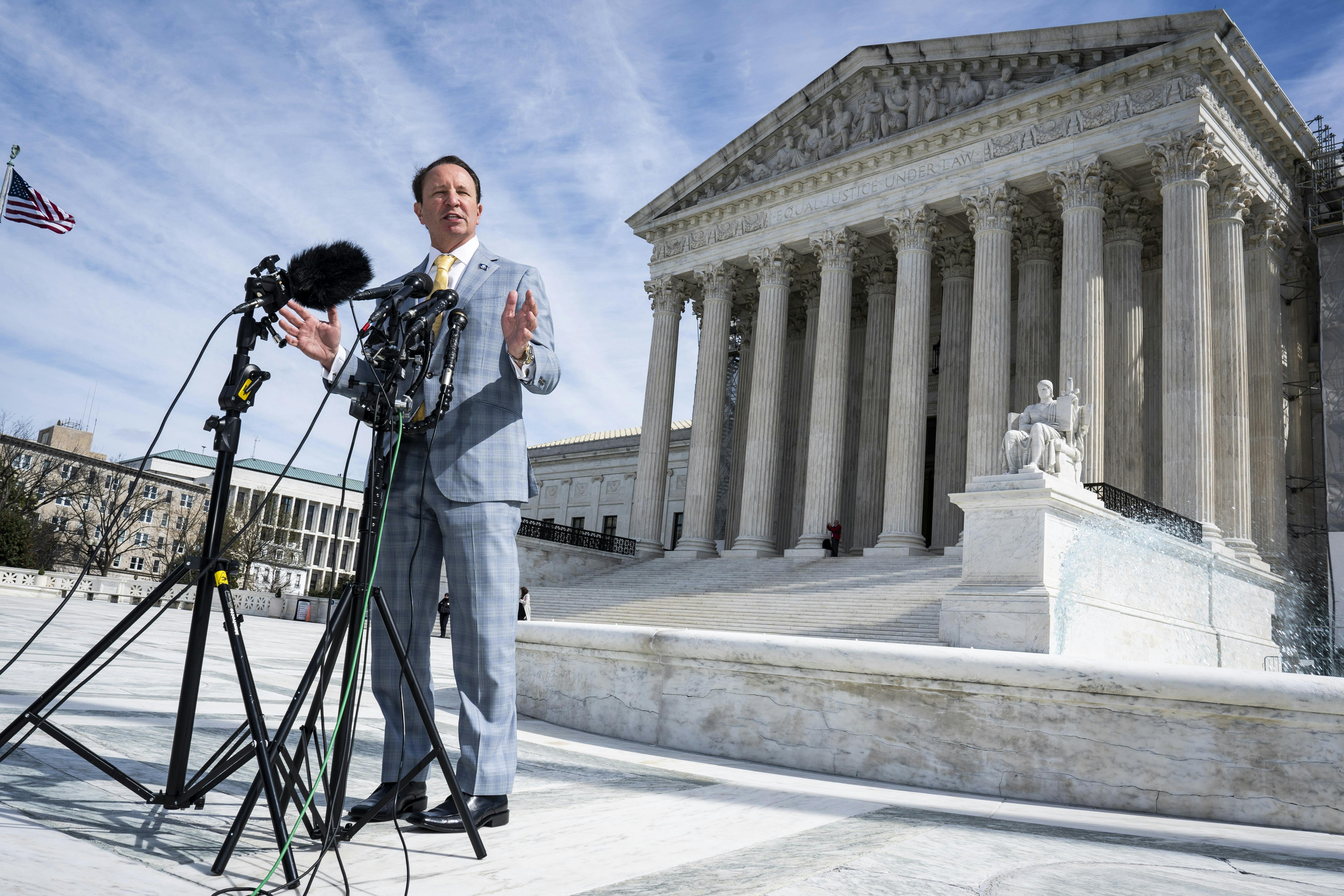 Louisiana Governor Jeff Landry speaks in front of the Supreme Court.