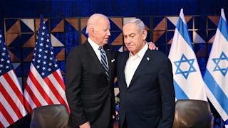 Biden slings an arm around Netanyahu's shoulders, with Israeli and American flags in the background.