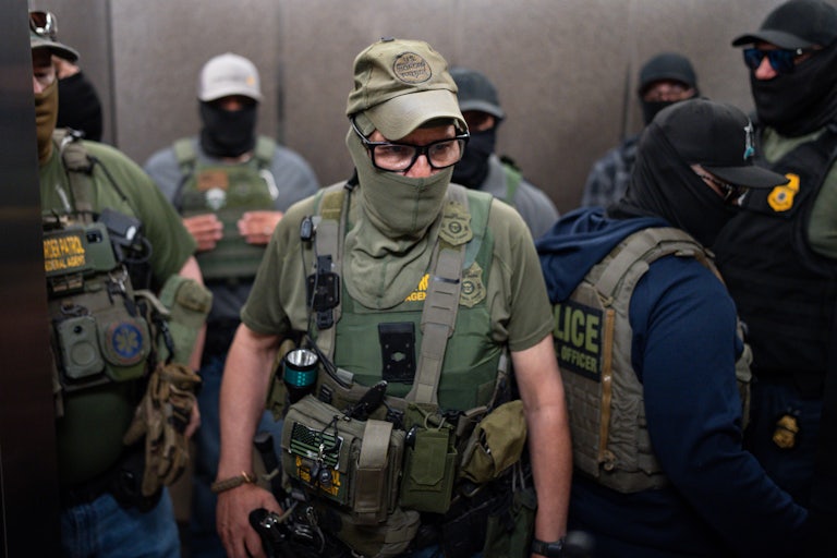 Masked ICE agents wearing police vests